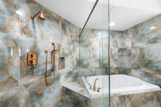 bathroom featuring plus walk in shower and tile walls