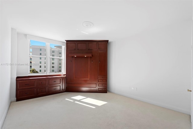 unfurnished bedroom featuring light carpet