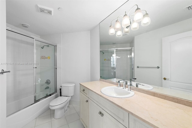 full bathroom featuring tile patterned floors, vanity, enclosed tub / shower combo, and toilet