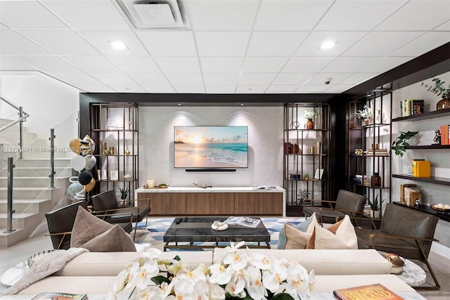 living room featuring a drop ceiling