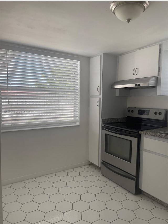 kitchen featuring white cabinets, stainless steel range with electric cooktop, and range hood