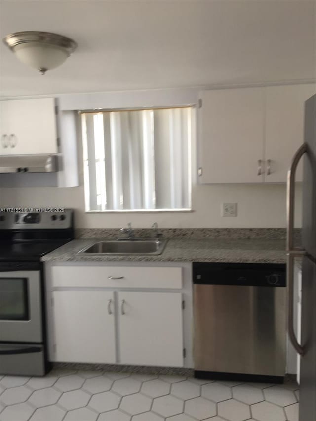 kitchen with sink, white cabinets, exhaust hood, and appliances with stainless steel finishes