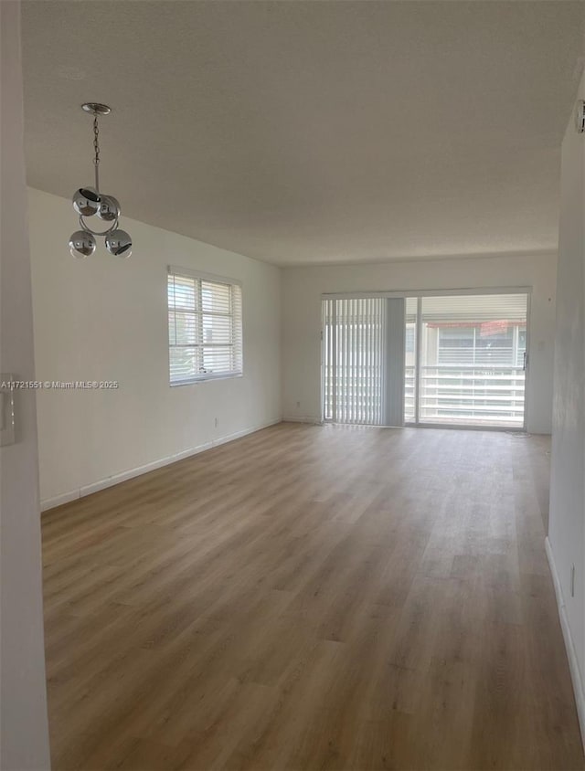 unfurnished room with hardwood / wood-style flooring