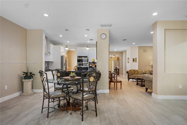 dining area featuring ceiling fan and light wood-type flooring