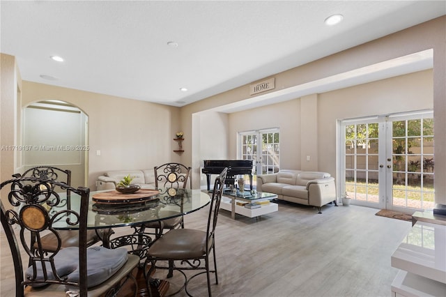 dining room with french doors and hardwood / wood-style floors