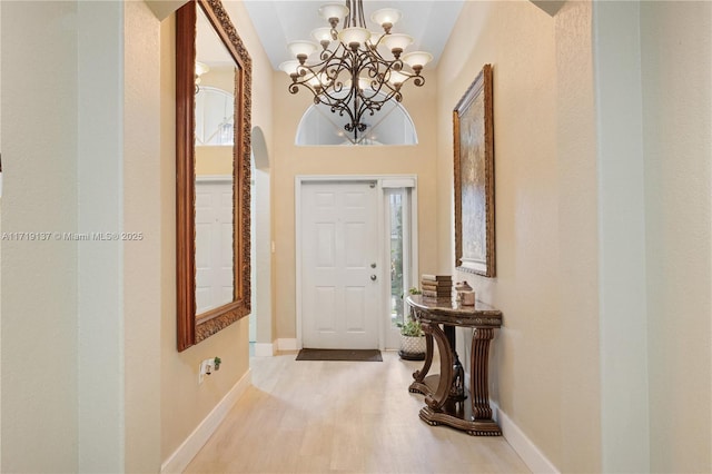 entrance foyer with a chandelier and light wood-type flooring