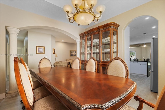 dining area with a chandelier and light hardwood / wood-style floors