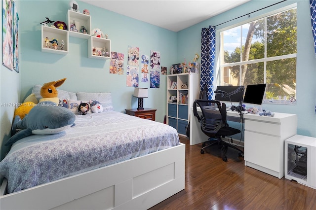 bedroom with beverage cooler and dark wood-type flooring