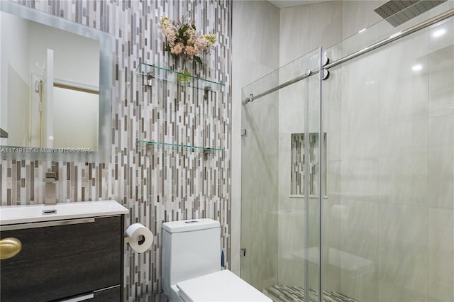 bathroom featuring vanity, toilet, an enclosed shower, and tile walls