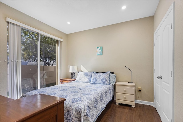 bedroom with access to outside and dark hardwood / wood-style floors