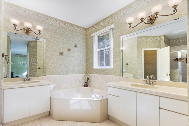 bathroom featuring tile patterned flooring, vanity, and a tub