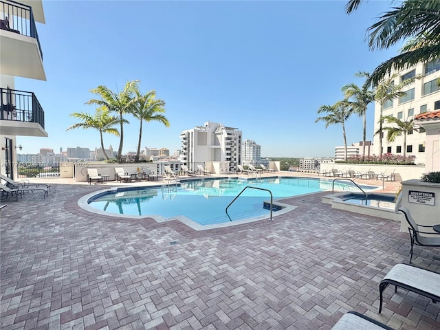 pool with a city view and a patio area