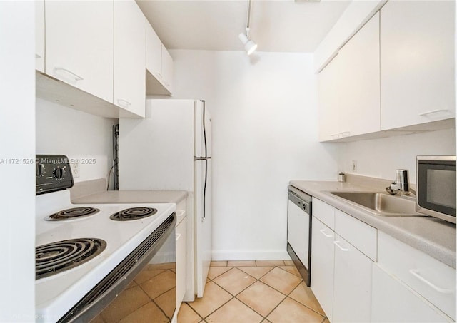 kitchen featuring white cabinets, white appliances, sink, and light tile patterned floors