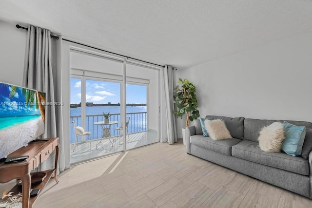 3020 Marcos Dr Unit S504, Aventura, FL 33160 - living room with floor to ceiling windows, a water view, and a textured ceiling