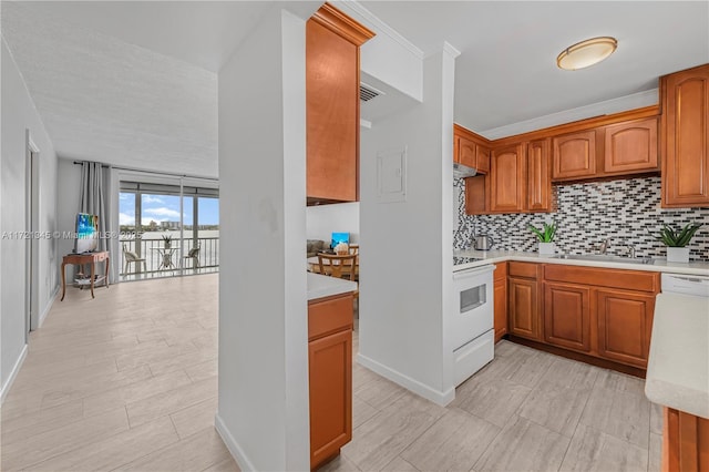 kitchen with white appliances, backsplash, crown molding, and sink