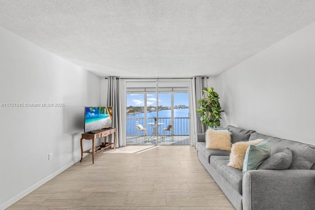 living room featuring a textured ceiling and expansive windows