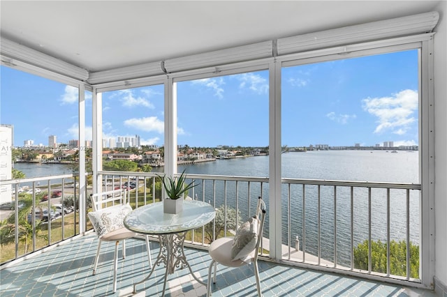 sunroom / solarium featuring a water view and a wealth of natural light