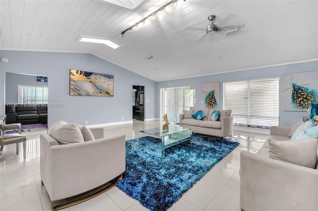 tiled living room featuring rail lighting, lofted ceiling with skylight, ceiling fan, and wooden ceiling