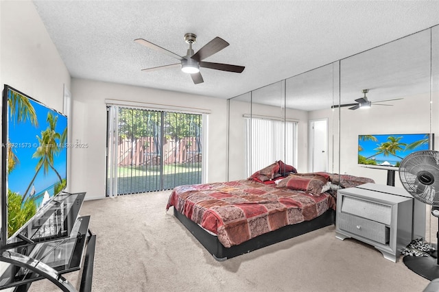 carpeted bedroom featuring a textured ceiling, access to outside, and ceiling fan