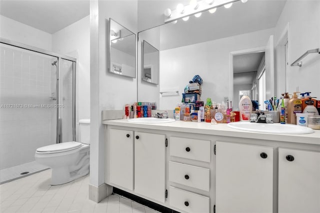 bathroom featuring tile patterned floors, vanity, toilet, and an enclosed shower