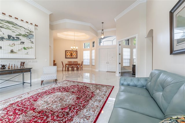 living room with a chandelier and crown molding