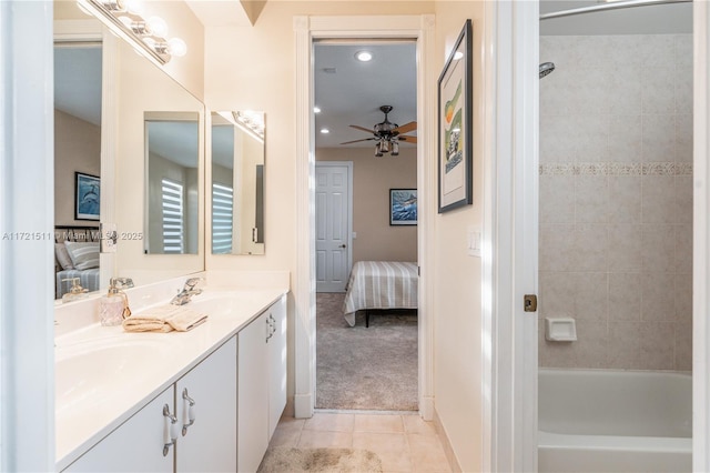 bathroom with tile patterned flooring, vanity, ceiling fan, and tiled shower / bath