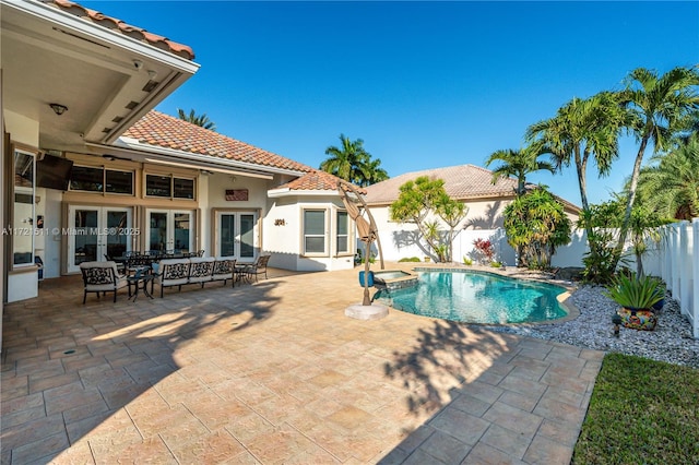 view of pool featuring a patio area and french doors