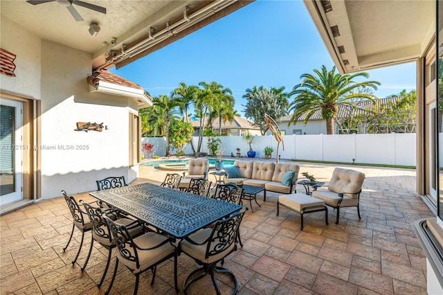 view of patio / terrace featuring an outdoor living space, ceiling fan, and a fenced in pool