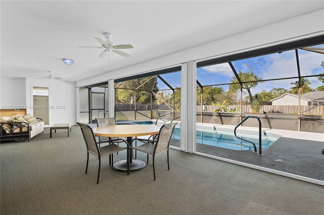 sunroom featuring ceiling fan