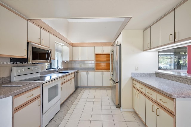 kitchen featuring decorative backsplash, sink, light tile patterned floors, and stainless steel appliances