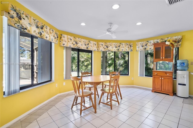 dining area with light tile patterned floors and ceiling fan