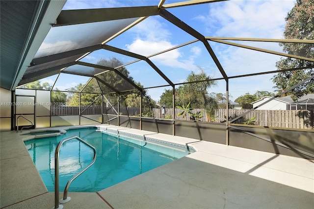 view of swimming pool with a patio and glass enclosure