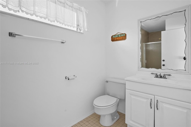 bathroom with vanity, toilet, and a shower with door