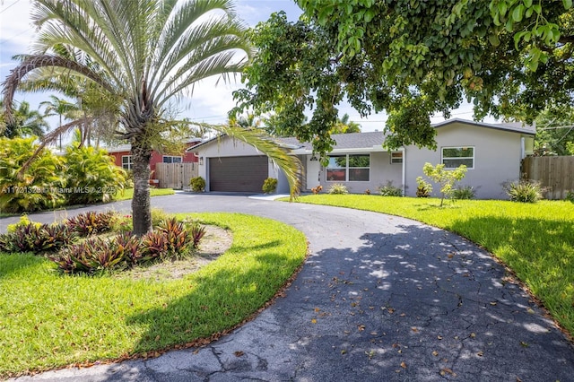 ranch-style home with a front lawn and a garage