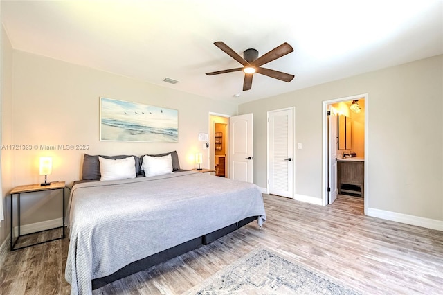 bedroom with ensuite bathroom, ceiling fan, and wood-type flooring