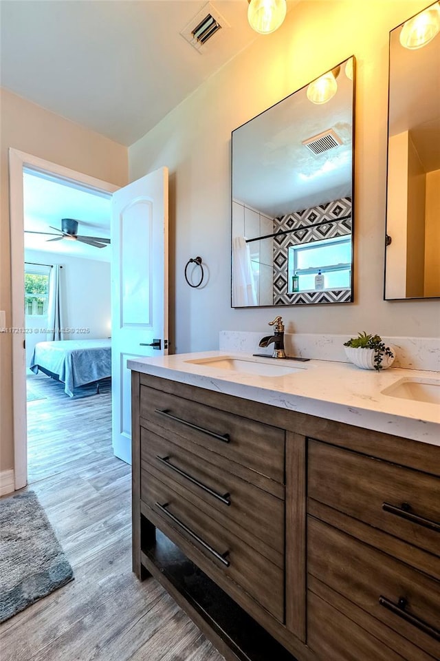 bathroom featuring vanity, hardwood / wood-style floors, and ceiling fan