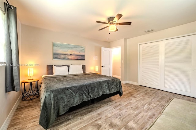 bedroom with light hardwood / wood-style floors, a closet, and ceiling fan
