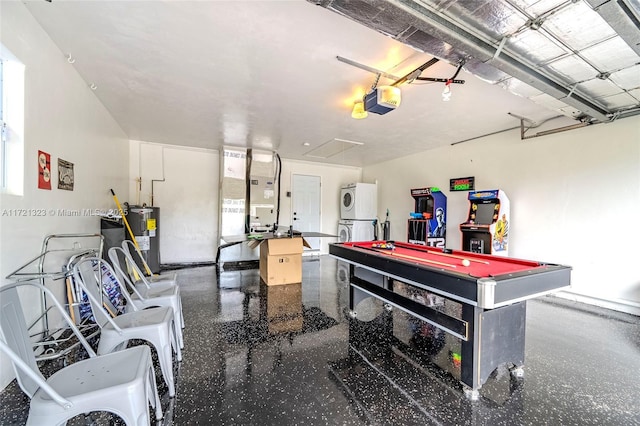 garage with heating unit, stacked washer / dryer, water heater, and a garage door opener