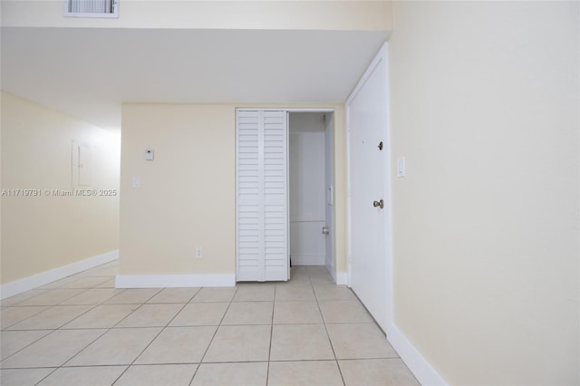 unfurnished bedroom featuring a closet and light tile patterned flooring