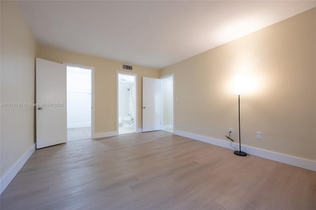 empty room with light hardwood / wood-style flooring