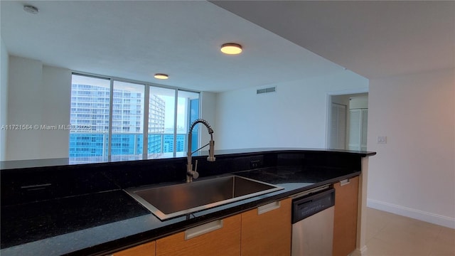 kitchen featuring dishwasher, light tile patterned floors, and sink