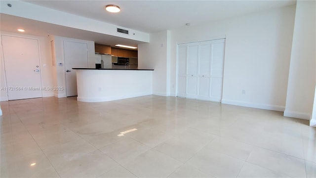 unfurnished living room featuring light tile patterned floors