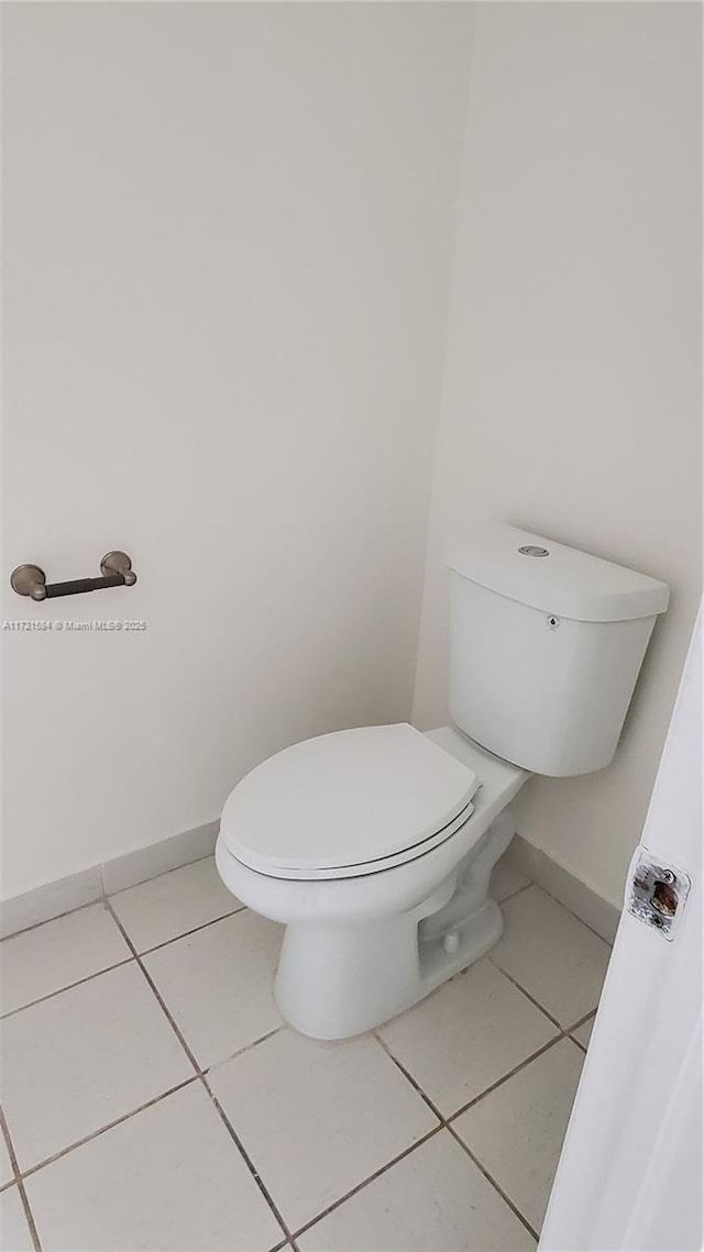 bathroom featuring tile patterned flooring and toilet