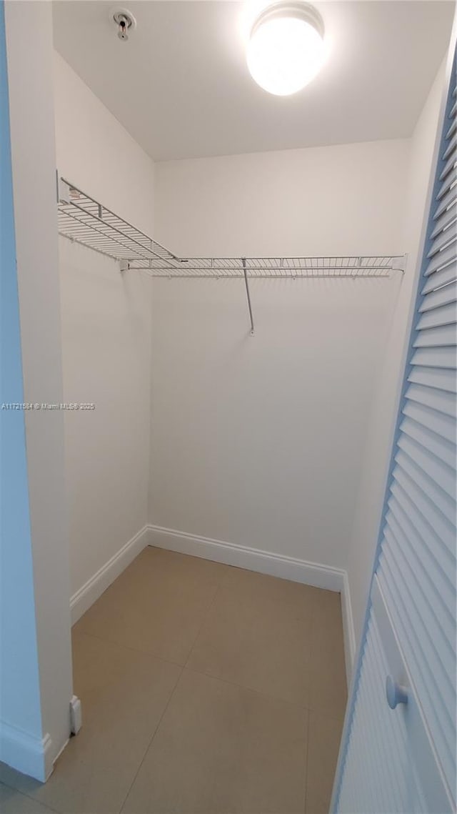 spacious closet featuring tile patterned flooring