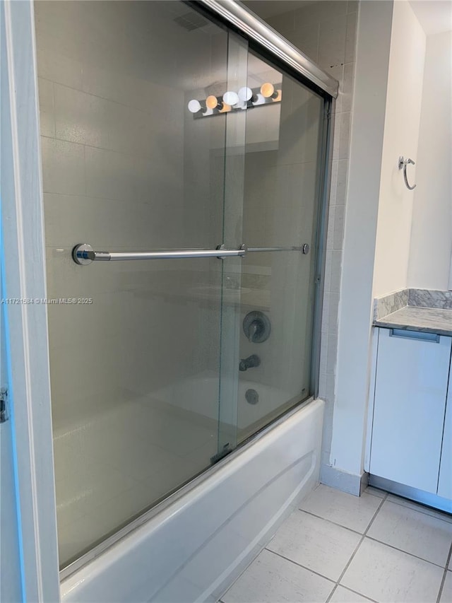 bathroom featuring combined bath / shower with glass door and tile patterned floors