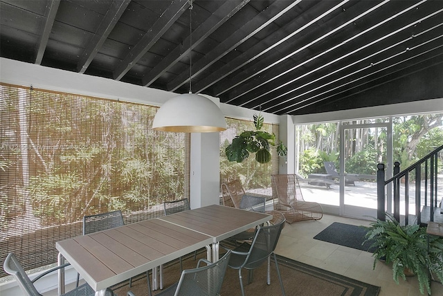 interior space featuring beam ceiling, high vaulted ceiling, and tile patterned floors