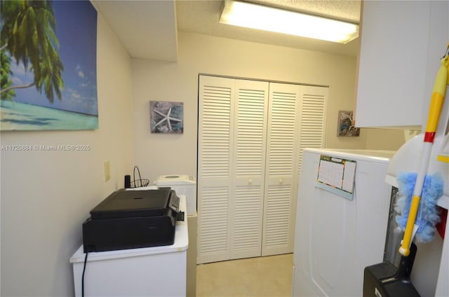 laundry area with light tile patterned flooring