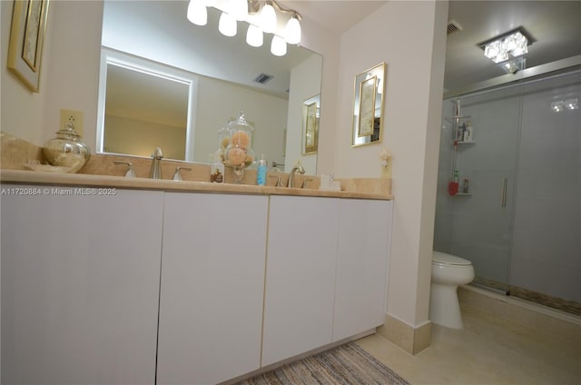 bathroom with tile patterned floors, vanity, toilet, and an enclosed shower