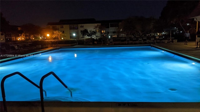 view of pool at night