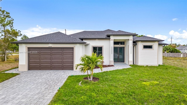 view of front of home featuring a garage and a front lawn